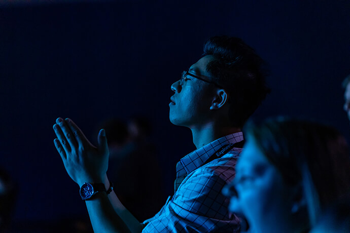A man prays during the 2019 EXPLORATION conference for young adults.  The event offers an opportunity for young people to “explore their purpose, calling and future.” File photo by Joseph McBrayer.
