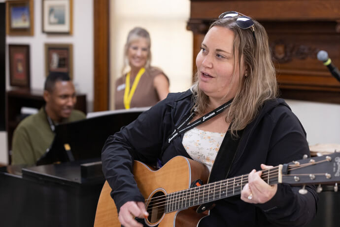 Crystal Crandall Danger plays guitar, and Daijreous Poole (left) plays the piano during a workshop on understanding and reading music charts taught by Kiersten Rose (center) at the Fusion 2026 Worship Music Conference.