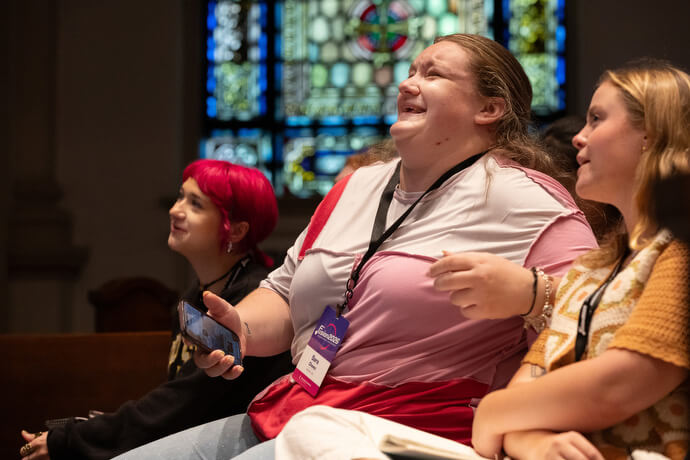 Sara Chavez (center) laughs at some of the results of a live, on-screen poll during the Fusion 2026 Worship Music Conference. With her are Zayna Snipes (left) and Karson Dickens.