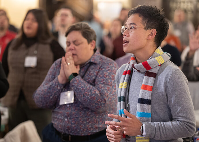 Pai Koehler-Masavisut (right) and Sam Blewis (center) sing during worship Oct. 22 at the United Methodist Leadership Gathering at Knox United Church in Calgary, Canada. Photo by Mike DuBose, UM News.
